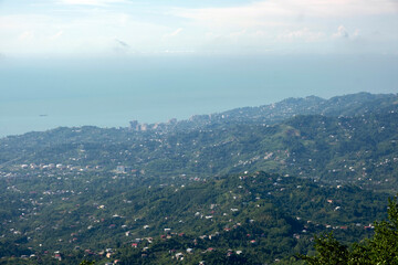 Fototapeta premium High angle view of rolling green hills, rural settlements and the Black Sea coast near Batumi, Georgia