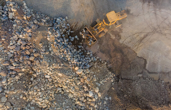 Mining Work of Wheel Dozer Carrying Boulders Rock in Industrial Rock Crusher Facility