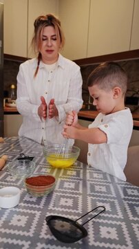Mother and son cooking together in the kitchen