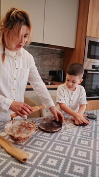 Mother and son bonding over baking in the kitchen