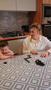 Mother and son bonding through a game of dominoes