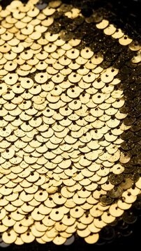 Close Up of Flipping Gold and Black Sequins Fabric