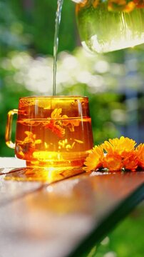 Calming calendula fasting tea poured into glass mug