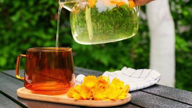 Calming homegrown calendula fasting tea in garden setting