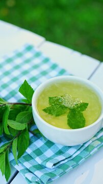 Refreshing homegrown mint tea in white cup
