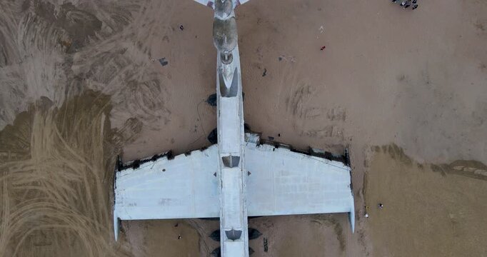 Top down aerial view of the massive T-tail stabilizer of the abandoned Soviet Lun-class ekranoplan on the sand beach