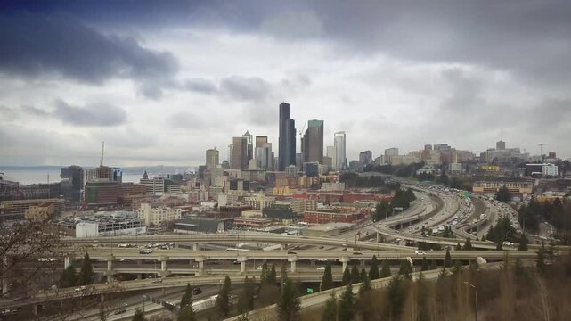 Seattle city skyline with heavy traffic on interstate five highway under cloudy grey winter sky in washington state.