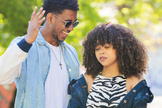 young couple on the street arguing angrily