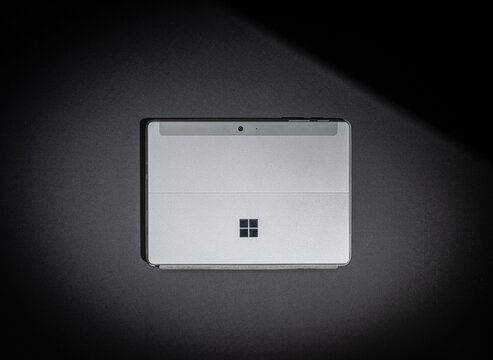 Gothenburg, Sweden - October 10 2023: Back view of Microsoft Surface Go tablet on dark surface.
