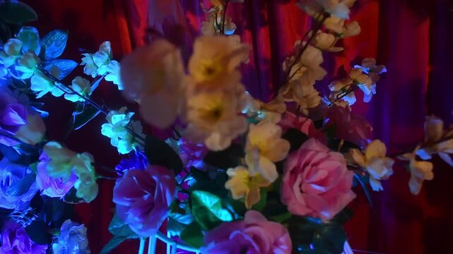 The decorative wedding backdrop features flowers, lights, floral arches, and festive stage elements used during marriage celebrations and cultural events.