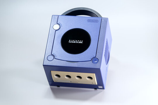 Fukuoka, Japan. June 6, 2026: Indigo Nintendo GameCube console photographed from above showing its compact cube body, disc lid and rear carrying handle.