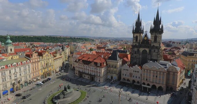 4K panning left motion High angle view of the Jan Hus Monument and the Tyn Church in background at the old town square in the city of Prague, Czech Republic, Europe