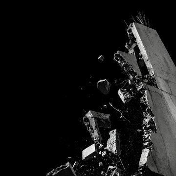 Exploding Concrete Wall with Flying Debris and Shards on Black Background