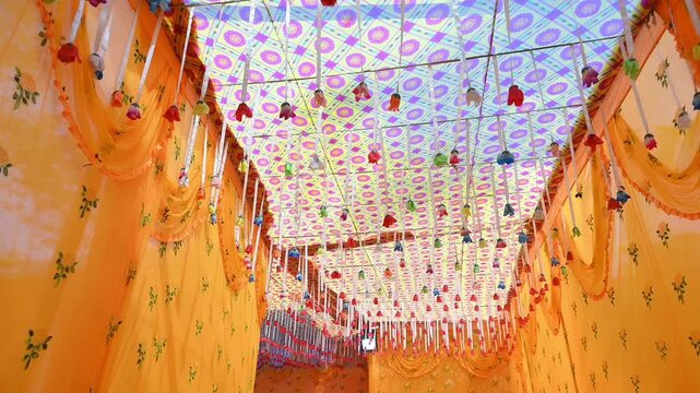 Traditional Indian Wedding Stage Decor with Flowers and Lights, Colorful floral decorations and marigold garlands arranged for an Indian wedding ceremony. The decorative wedding backdrop