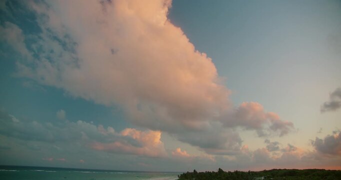 Soft evening cloud fills blue sky above tropical Caribbean coast in Tulum Mexico