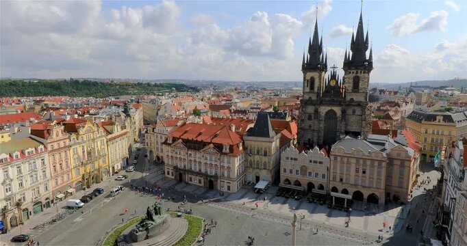 4K panning right motion High angle view of the Jan Hus Monument and the Tyn Church in background at the old town square in the city of Prague, Czech Republic, Europe