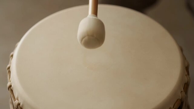 Close-up of a drum with a mallet.