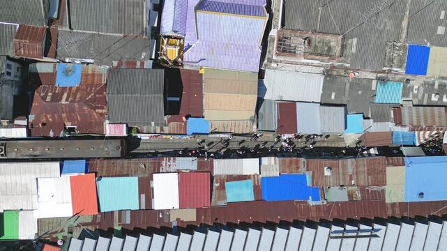 Aerial View Of Busy Market. Drone Footage Showcasing Bustling Market Alleyways And Colorful Rooftops