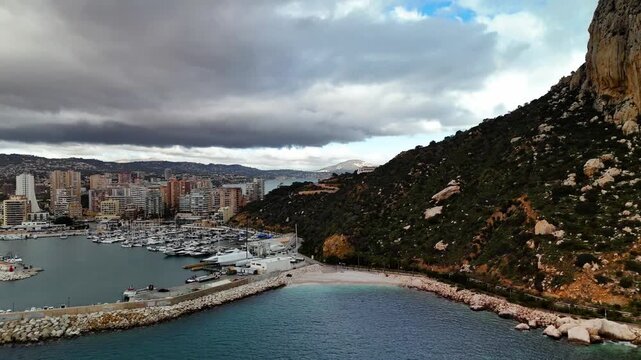 Aerial view of Penon de Ifach slopes and Calpe marina, Spain