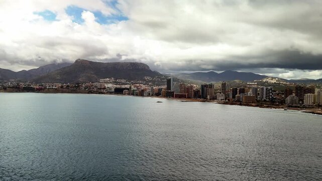 Aerial wide shot of Calpe coastline and high rise buildings, Costa Blanca, Spain
