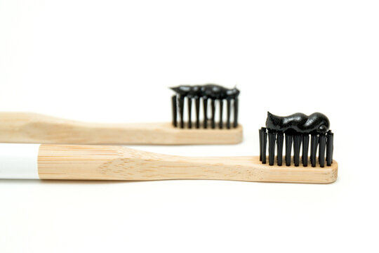 wooden toothbrushes with black toothpaste