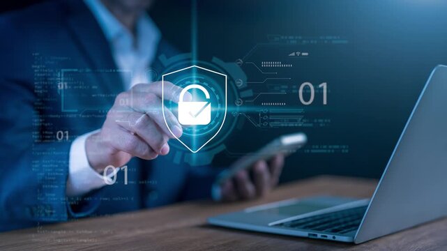 Close-up of a businessman touching a virtual shield icon with a padlock to secure data protection, cyber security, and network safety system on a smartphone and laptop.