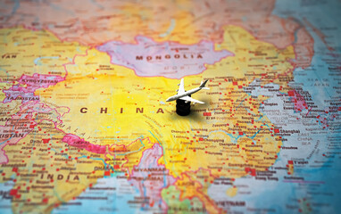 Naklejka premium Toy airplane on fuel barrel China map.