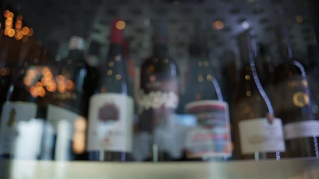Assorted wine bottles stored in a refrigerated display cabinet