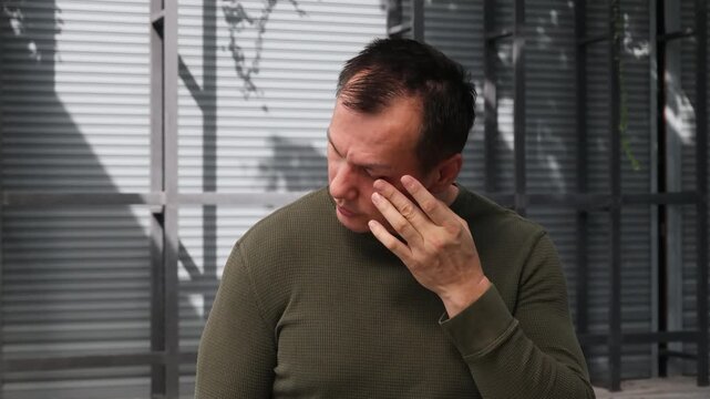 Portrait of visual-impaired asian uncl man with eye irritation, red eye or eye inflammation
