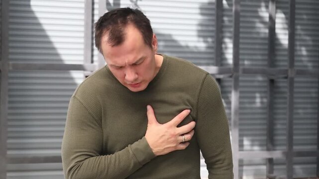middle aged old asian man with acid reflux sickness, GERD, breathing difficulty, health care concept image