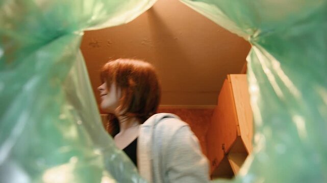 Throwing bottle into trash low angle video