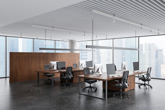 Modern open plan office interior with wooden desks, ergonomic chairs, panoramic city windows and contemporary design elements. 3D Rendering