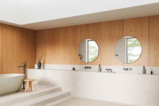 Serene minimalist interior bathroom with freestanding tub wooden wall panels round mirrors soft neutral tones natural light and elegant decor details. 3D Rendering