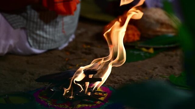 Close-up footage of a traditional Hindu puja setup featuring sacred offerings, marigold flowers, banana leaves, earthen pot, and ritual materials after a havan ceremony