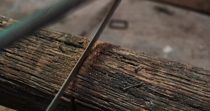 Hand, saw and manually cutting woodHand, saw and manually cutting wood. High quality 4k footage