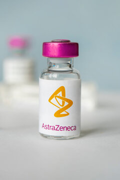 logo of the astrazeneca company on a glass bottle with liquid for injections.