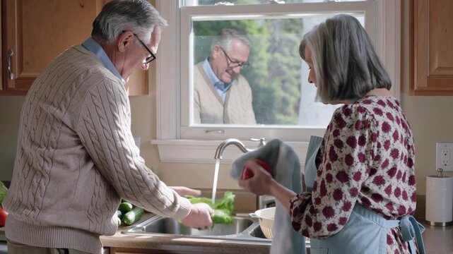 Senior couple washing vegetables together in a kitchen sink