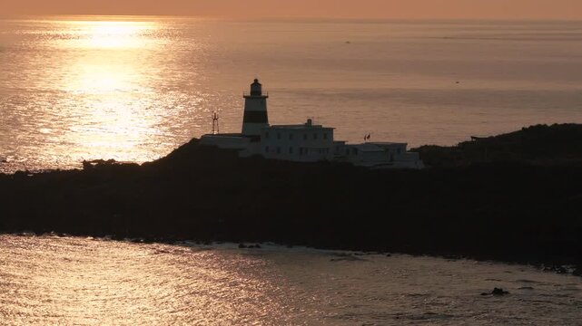 Aerial view of coastal lighthouse on rocky shore in Taiwan 