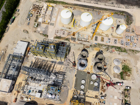 Construction site of a modern agricultural complex with silos, grain elevator and storage terminal. Aerial view