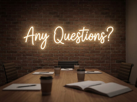 Neon sign displaying any questions on a brick wall in an empty conference room, ready for discussion