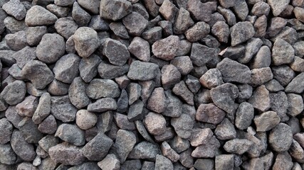 Naklejka premium ​Close-up of crushed grey stones texture, abstract gravel background