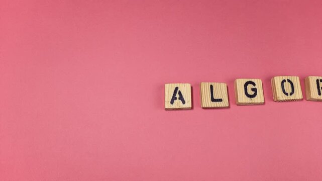 Algorithm Concept Displayed With Wooden Letter Tiles on Pink Background