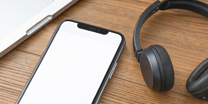 Digital communication through online learning and remote work with a smartphone that has a white screen and wireless headphones