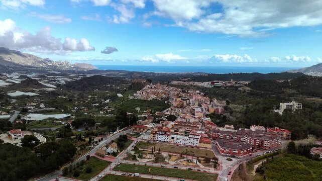 High altitude aerial drone approach to Polop town, Costa Blanca, Spain