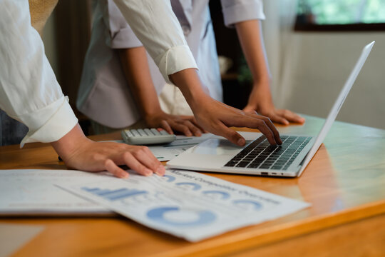 Hands typing on laptop keyboard reviewing market competitor overview data and financial reports during professional business analysis process