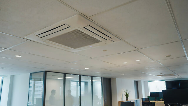 Modern recessed ceiling air conditioner unit in a bright building interior, providing comfortable climate control, efficient cooling and ventilation
