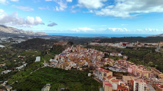 Aerial drone view of rooftops and castle in Polop, Spain