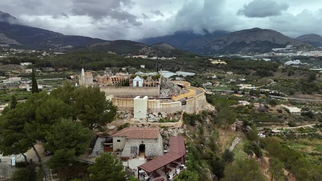Aerial drone view circling the historic Polop Castle, Alicante, Spain