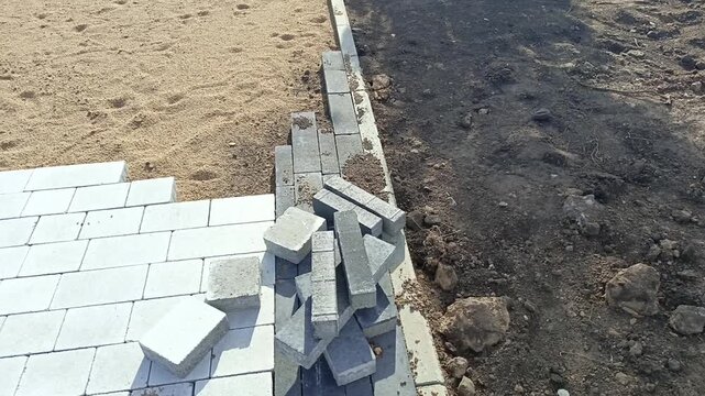 The process of laying paving slabs. Construction of roads in a park, city
