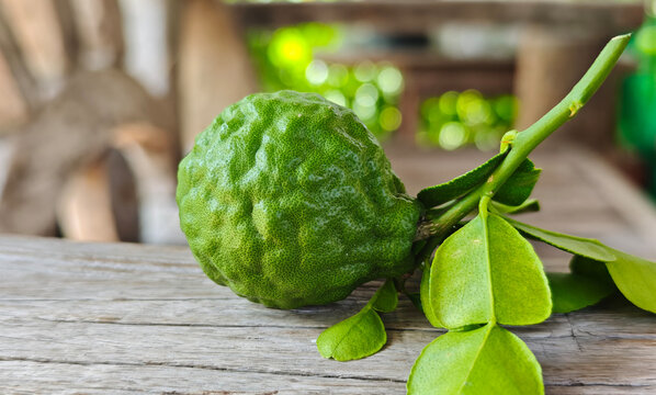 Fresh kaffir lime fruit on a wooden floor.